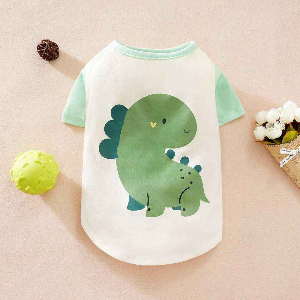 Cute white and mint green pet shirt with a smiling green dinosaur print on a beige background