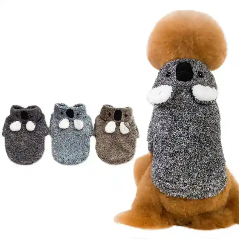 Small dog wearing gray koala-themed sweater with three additional koala sweaters in different colors on white background