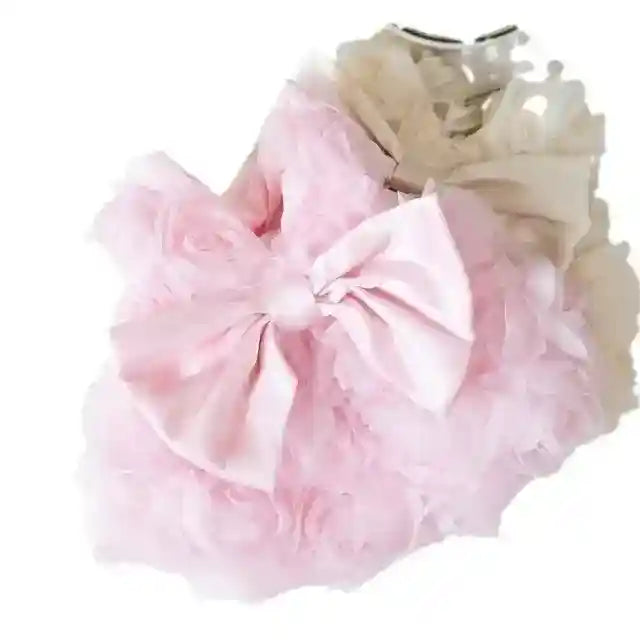 pink pet dress with large satin bow and ruffled floral texture on white background