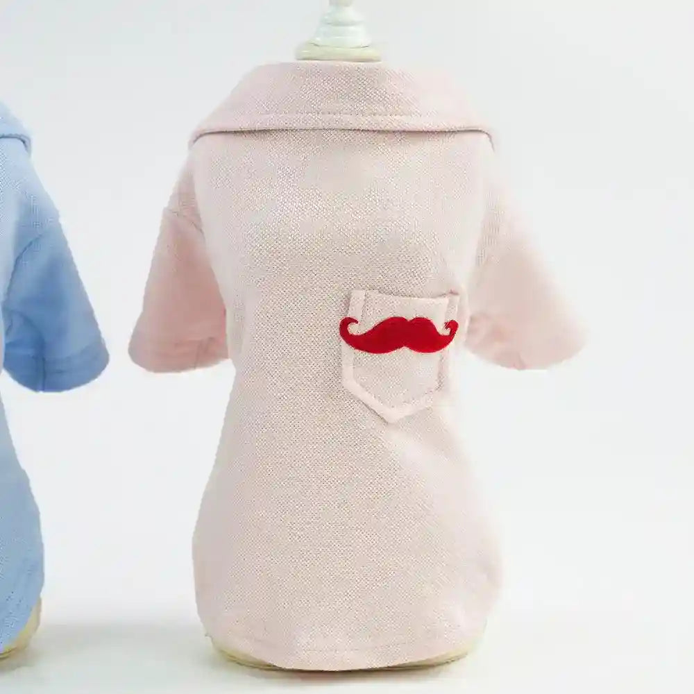 Light pink dog shirt with collar and pocket featuring red mustache design