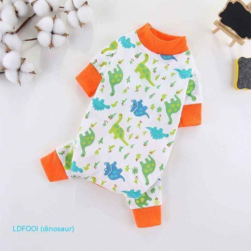 White baby bodysuit with colorful dinosaur prints and orange cuffs on a white surface