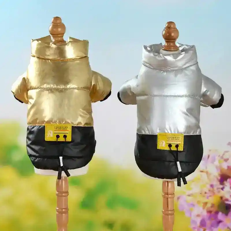 Gold and silver padded dog jackets with black bottoms on wooden mannequins against a floral background