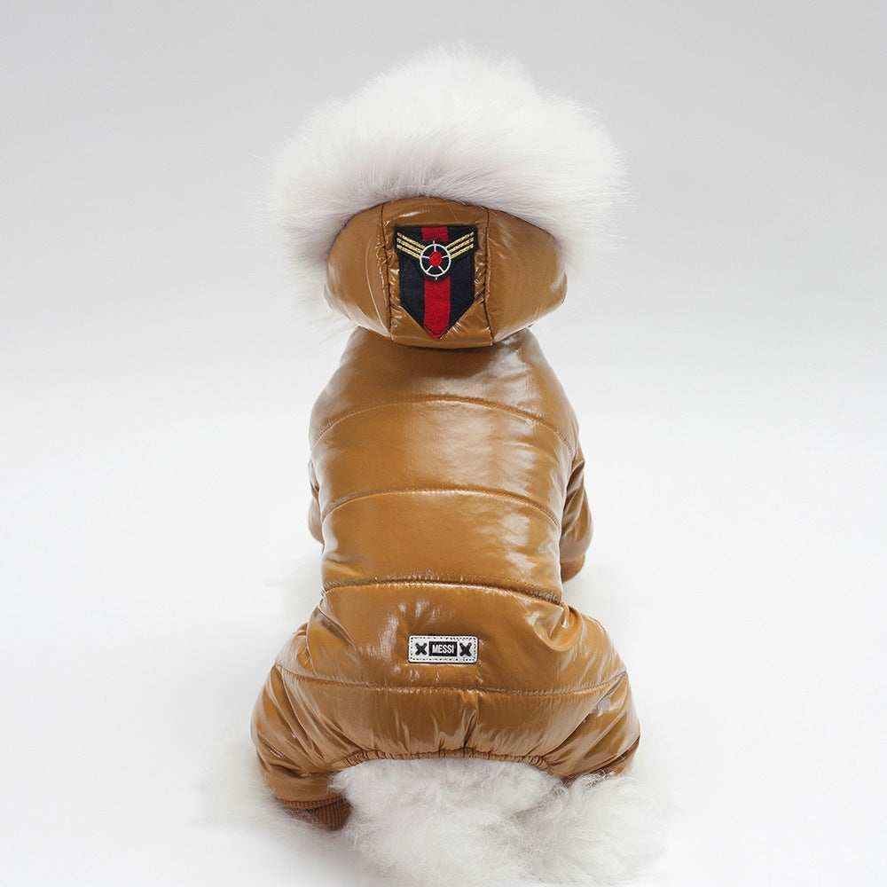 Small dog wearing a shiny brown puffer jacket with white fur hood and patches on back