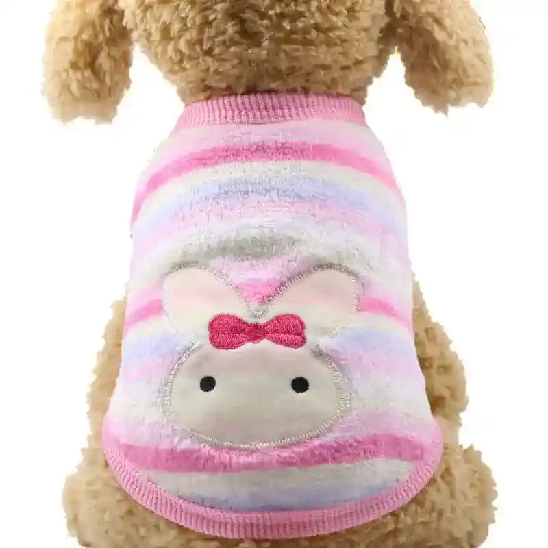 Dog wearing pink and pastel striped sweater with cute bunny face and bow design