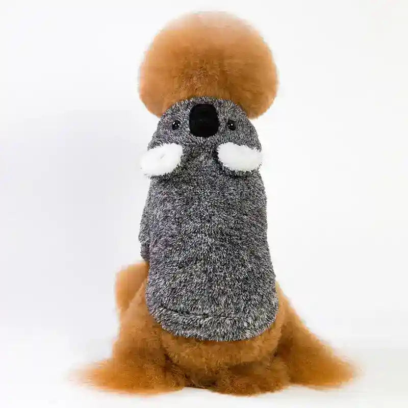 dog wearing a gray koala costume with a large orange fur headpiece and tail