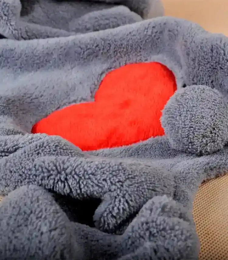 Soft gray fleece blanket with a bright red heart and a round pom-pom detail