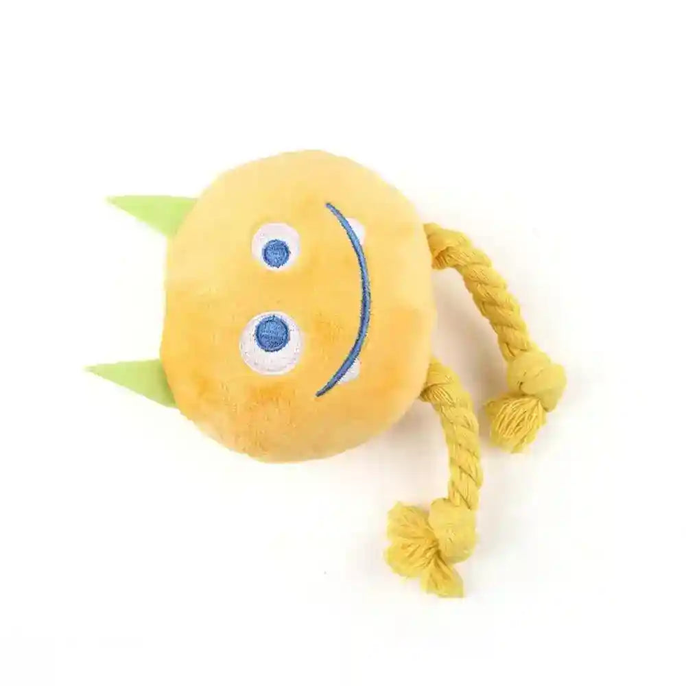 Yellow plush dog toy with smiley face, green horns, and knotted rope legs on white background