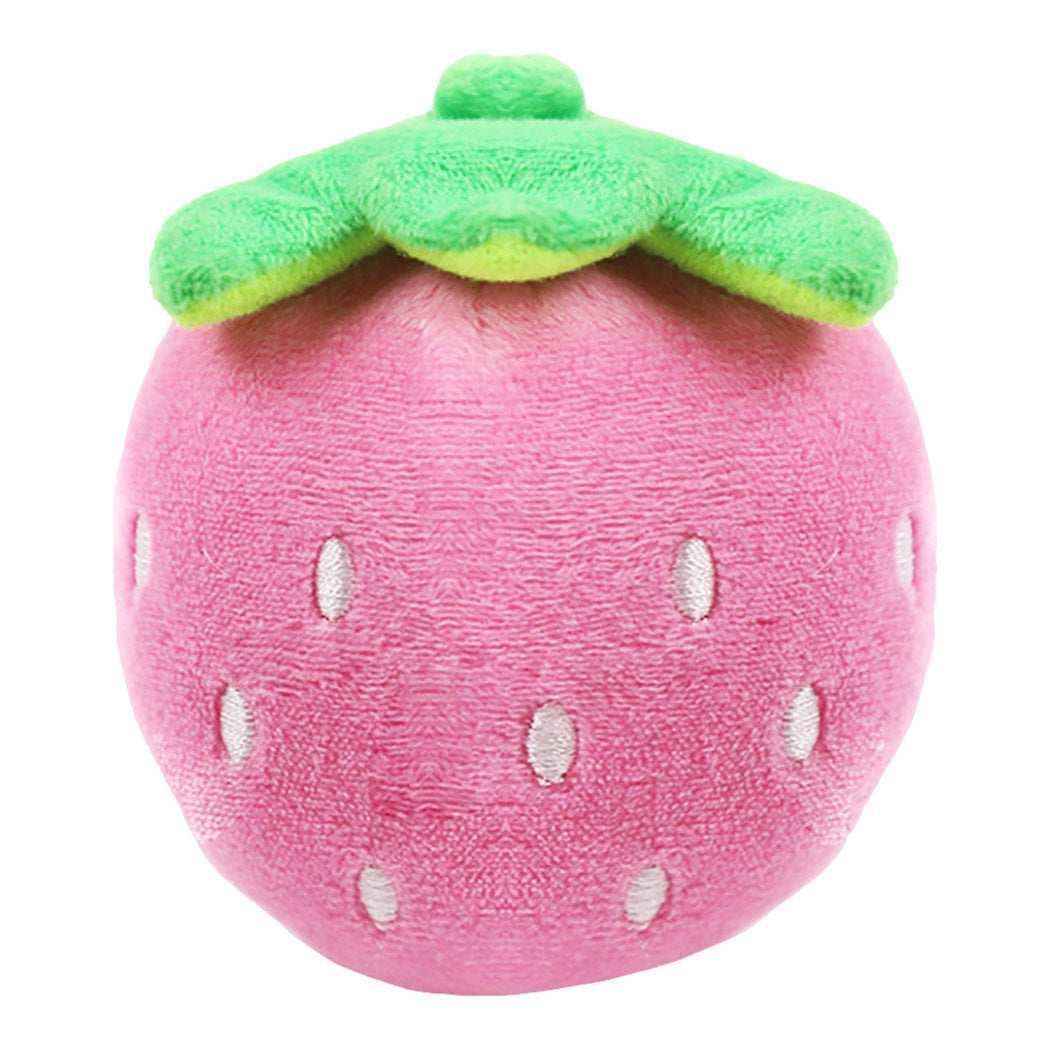 Soft pink plush strawberry toy with green fabric leaves and white embroidered seeds
