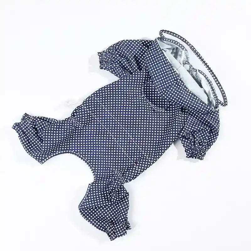 Navy blue dog raincoat with white polka dots and elastic cuffs on sleeves and legs
