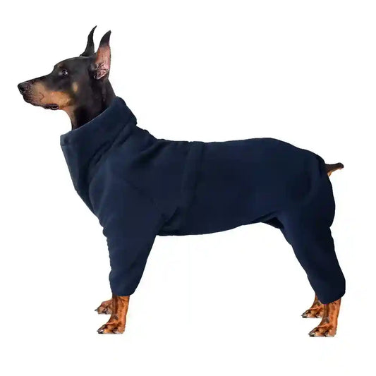 Doberman dog wearing navy blue full-body fleece jumpsuit on white background