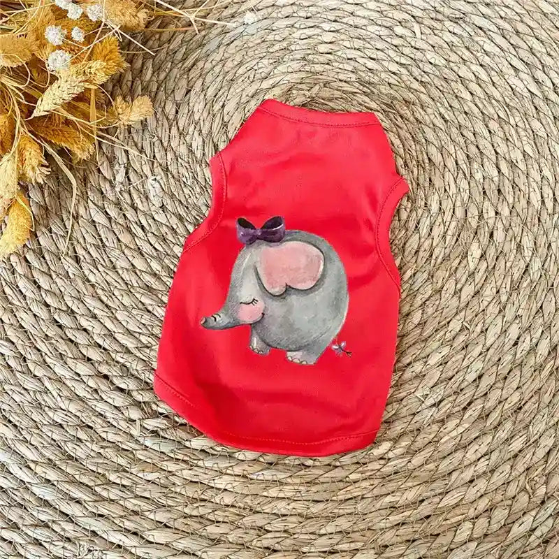 Red pet shirt with cute gray elephant and purple bow print on woven straw mat background