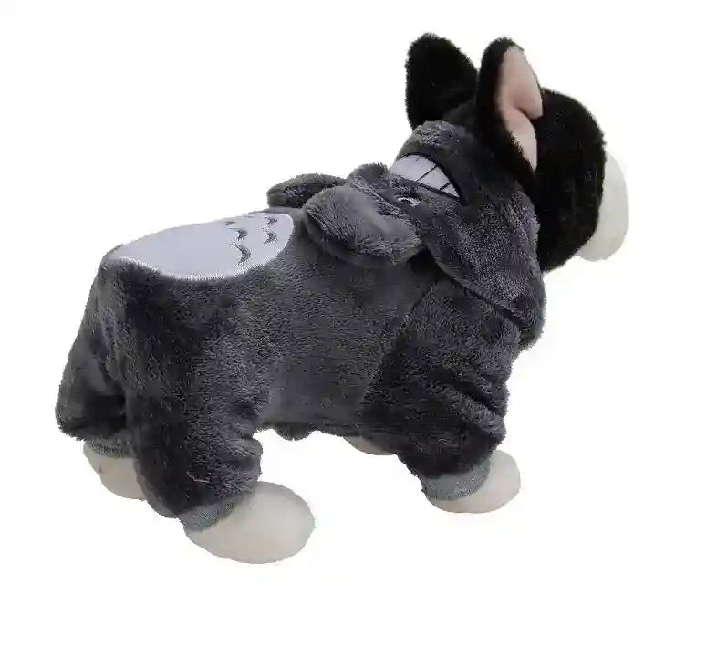 Black and white dog wearing a gray plush Totoro-themed costume with ears and tail