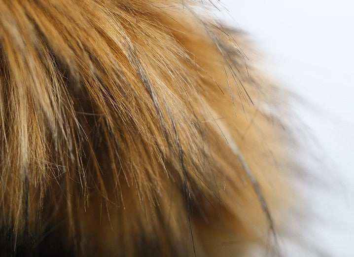 Close-up of brown and black faux fur texture with soft, fluffy strands