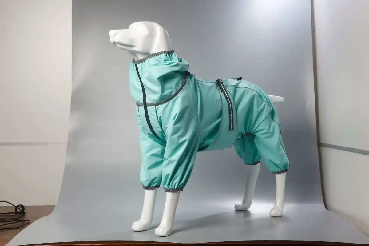 White dog mannequin wearing turquoise waterproof full-body dog raincoat with zipper