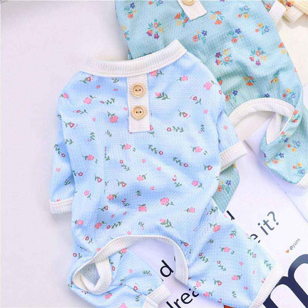 Two floral patterned baby romper suits in blue and green with button details and soft trim