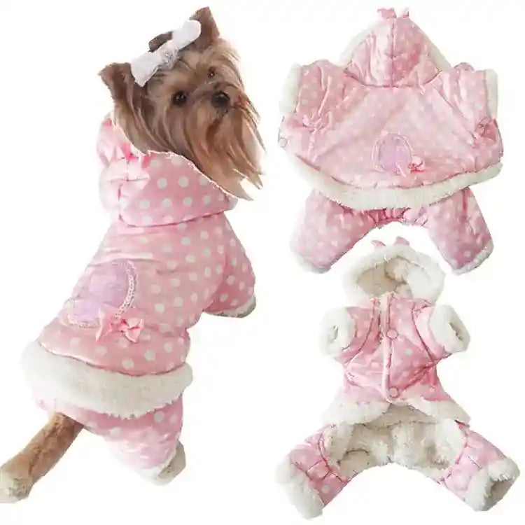 Small dog wearing pink polka dot winter coat with hood and white fur trim, cozy pet clothing
