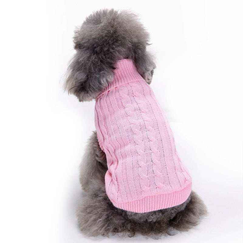Gray poodle dog wearing a pink cable knit sweater sitting against a white background