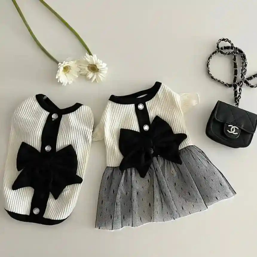 Small black and white dog clothes set with bows and buttons, paired with a mini black purse and two white flowers