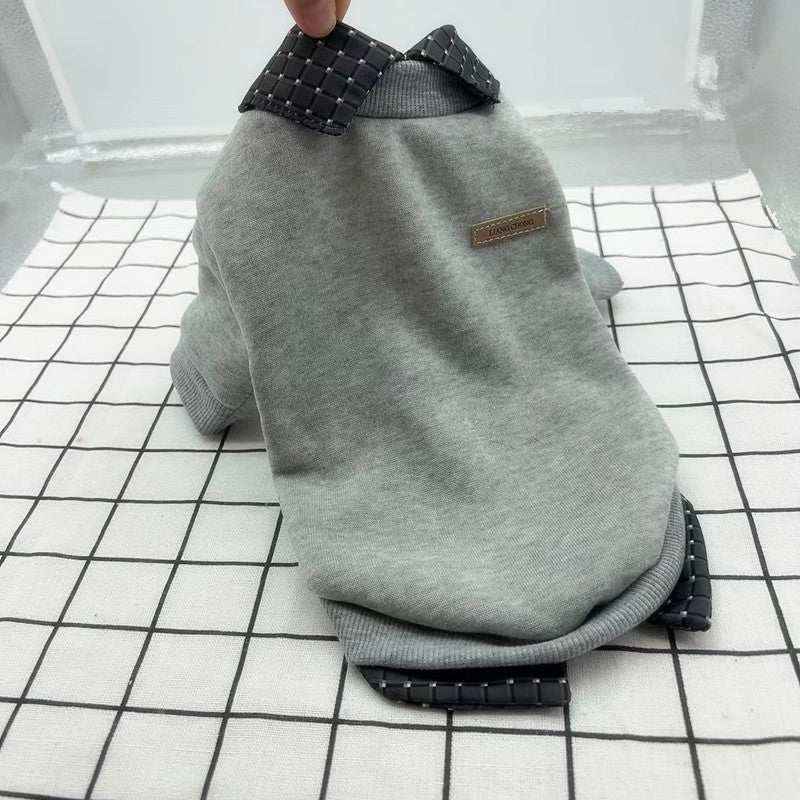 Gray dog sweater with checkered collar and cuffs on white grid background