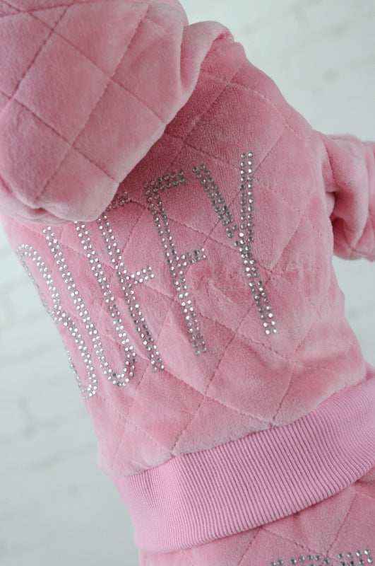 Pink quilted hoodie with rhinestone lettering spelling DUFFY on the back