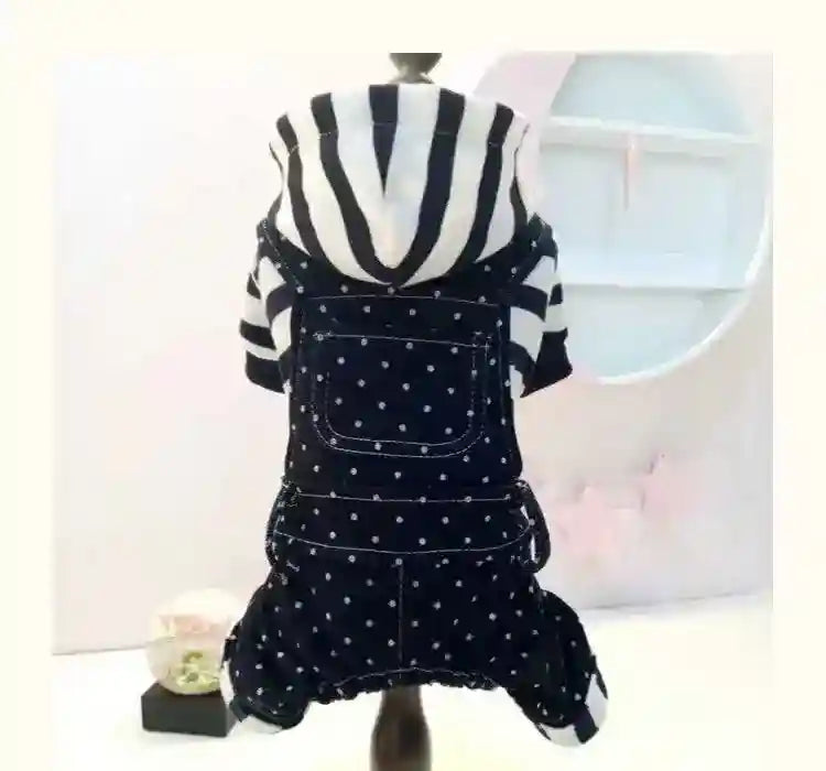 Black and white striped hoodie with navy blue polka dot overalls on pet mannequin in minimalist setting
