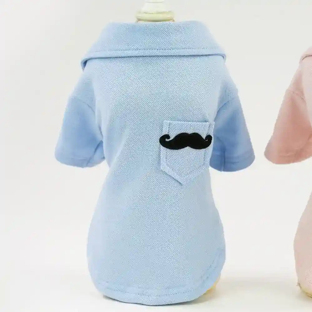 Light blue dog polo shirt with a small black mustache patch on the back pocket