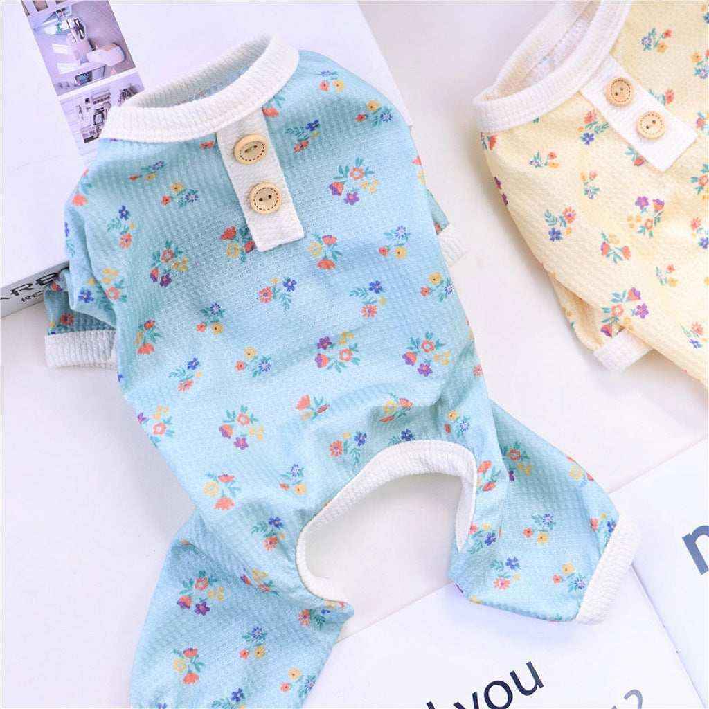 Floral print baby blue and cream knit rompers with button details on white surface