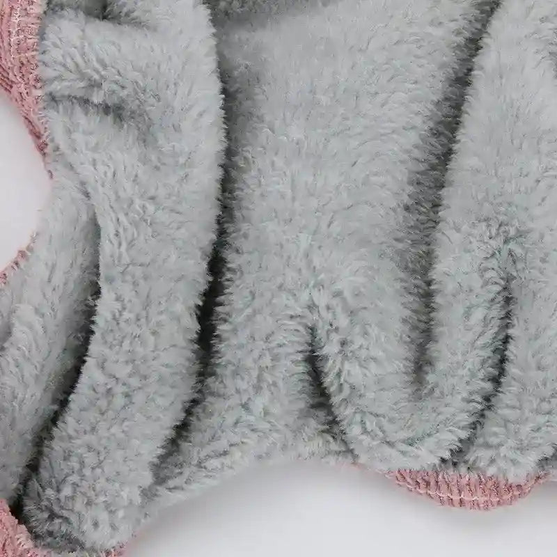 Close-up of soft gray fleece fabric with pink knitted edges, cozy warm textile detail