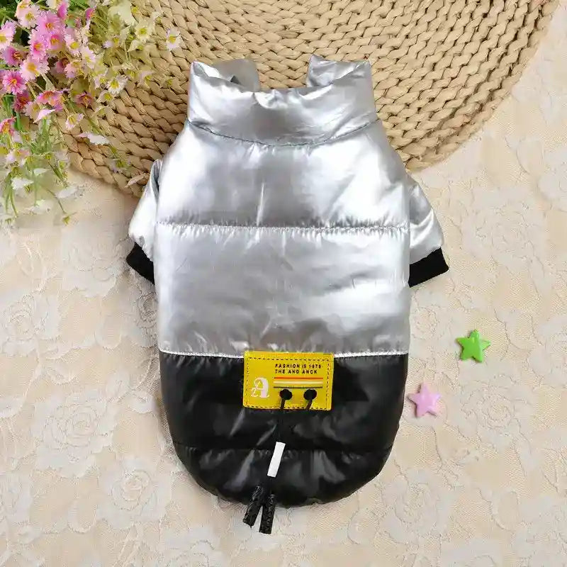 Silver and black dog jacket with yellow patch on lace and woven placemat background