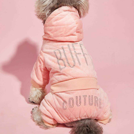 Small dog wearing a pink quilted BUBB COUTURE hoodie against a pink background