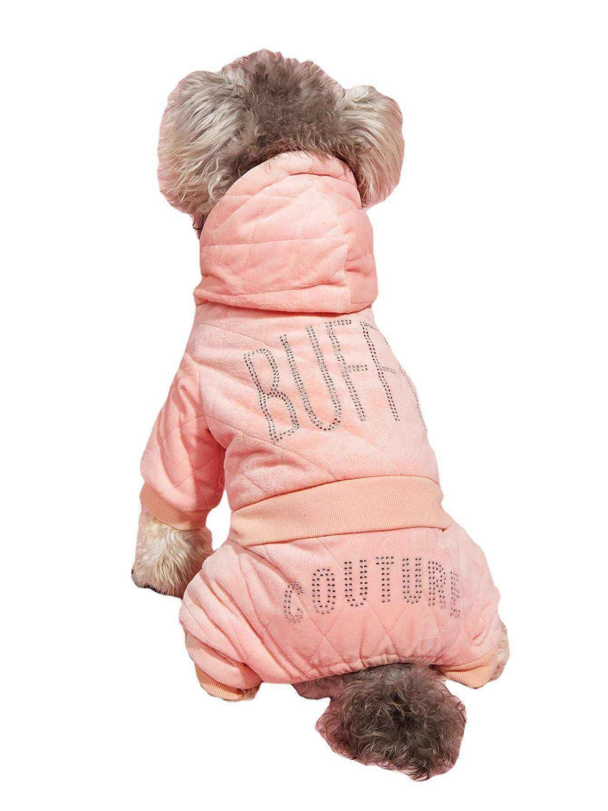 Small dog wearing a pink quilted hoodie and pants with rhinestone text reading BUFF COUTURE
