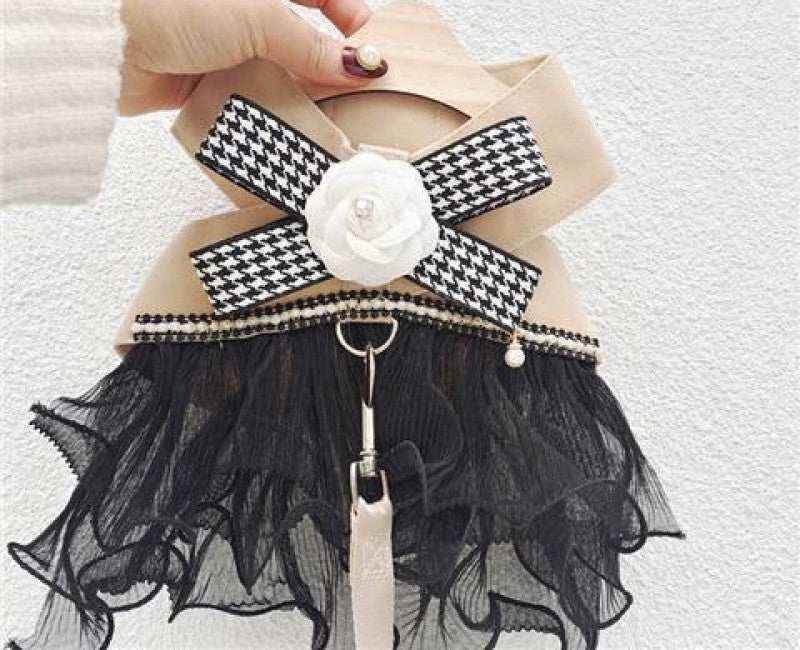 Beige handbag with black tulle fringe, checkered ribbon, white rose decoration, and pearl detail