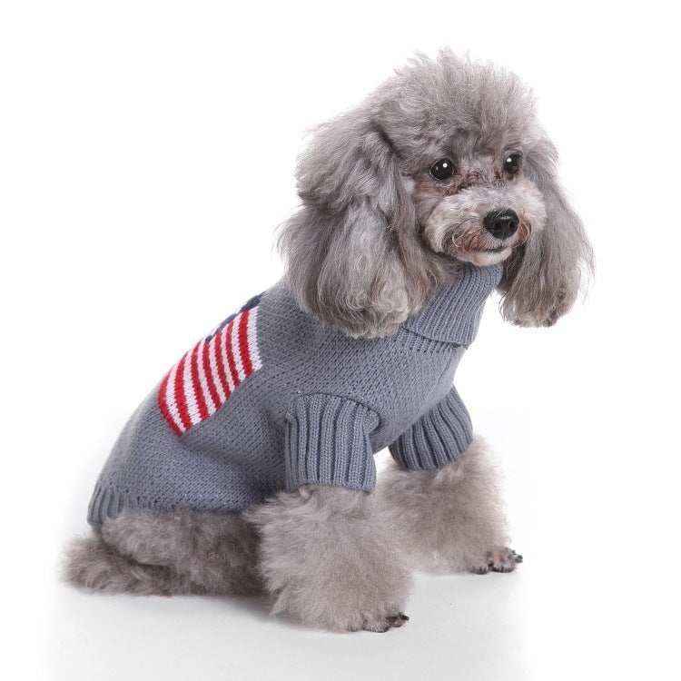 Gray poodle wearing a gray knit sweater with red and white stripes sitting on white background