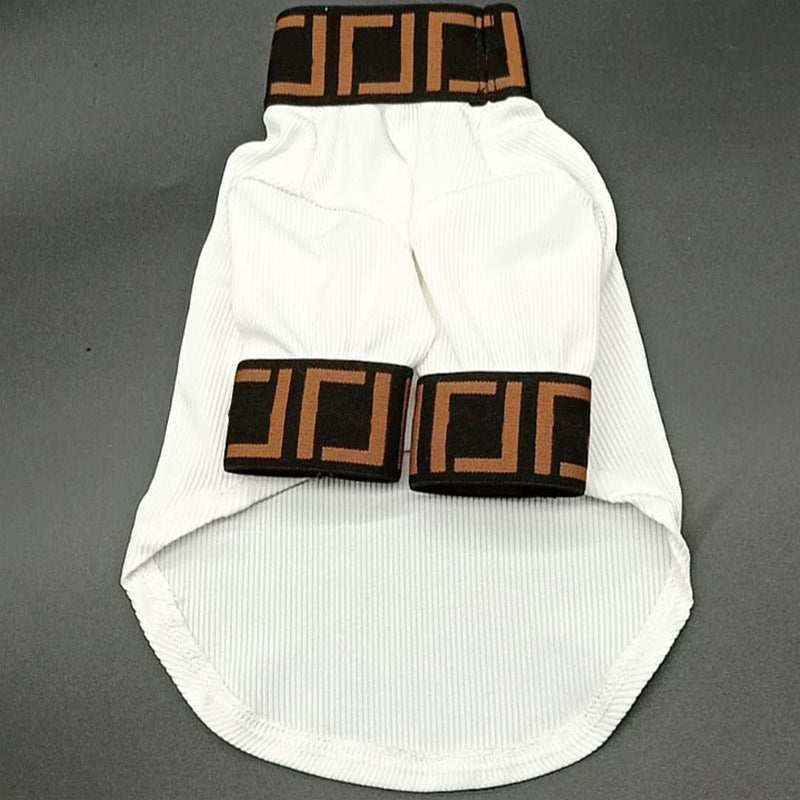 White dog sweater with black and brown geometric pattern on collar and sleeve cuffs