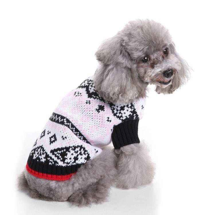 Gray poodle wearing a black and white patterned knit sweater with red trim on white background