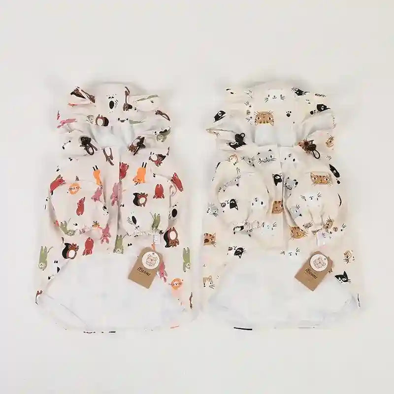 Two colorful animal print waterproof dog raincoats with hoods and adjustable toggles on white background