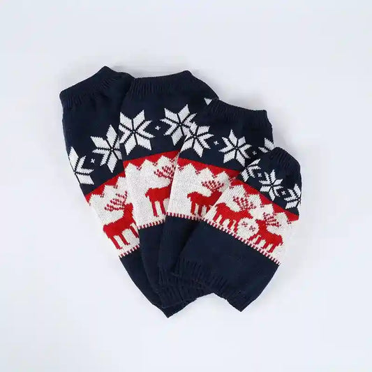 Set of four dark blue knitted holiday dog sweaters with white snowflakes and red reindeer patterns