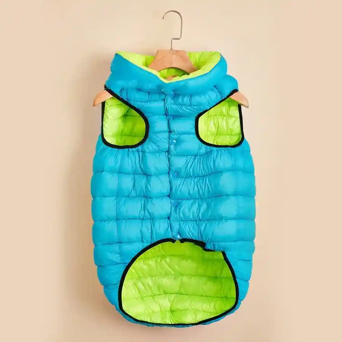 Blue and neon green padded dog vest with hood hanging on wooden hanger