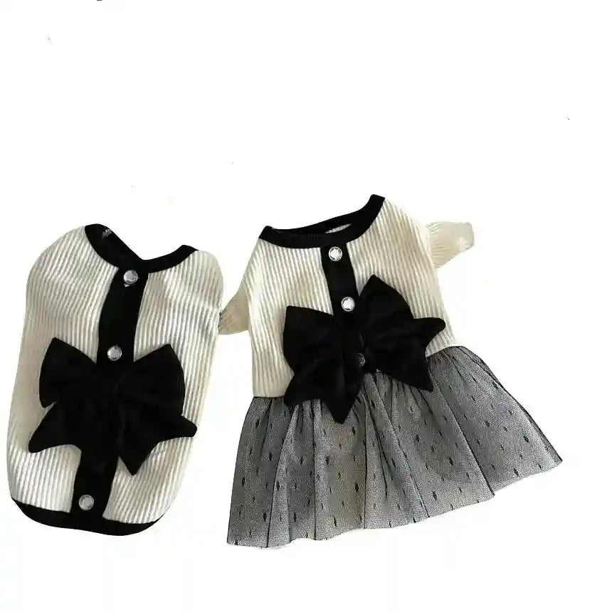 Elegant white dog sweater with black trim, large black bow, and tulle skirt detail