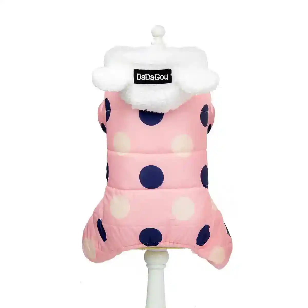 Pink dog winter jacket with large navy and white polka dots and white fleece collar on stand
