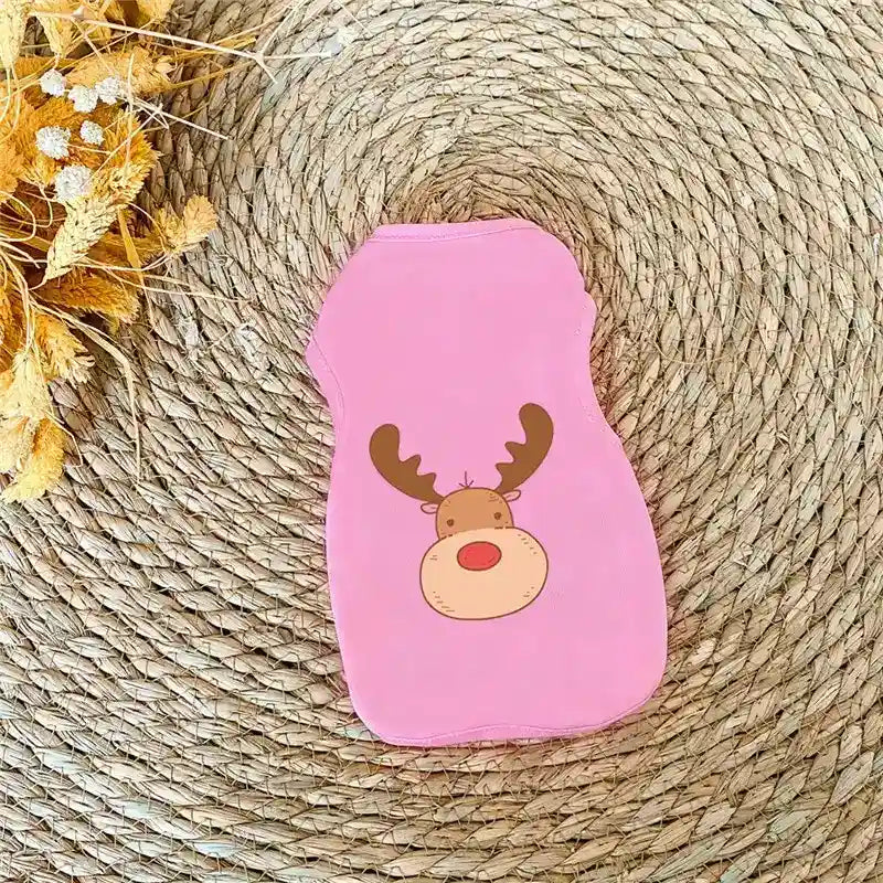 Pink pet shirt with cute cartoon reindeer print on woven natural fiber rug