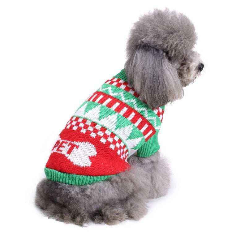 Gray poodle dog wearing a red, green, and white Christmas sweater with geometric patterns