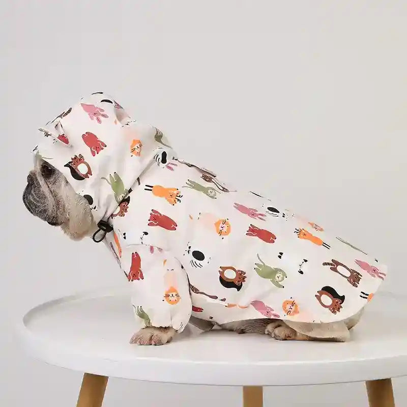 French bulldog wearing a colorful animal print raincoat with hood sitting on white round table