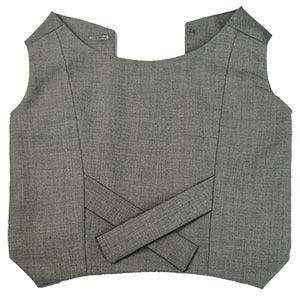 Grey structured textile bodice with angular shoulders and intersecting fabric bands across front