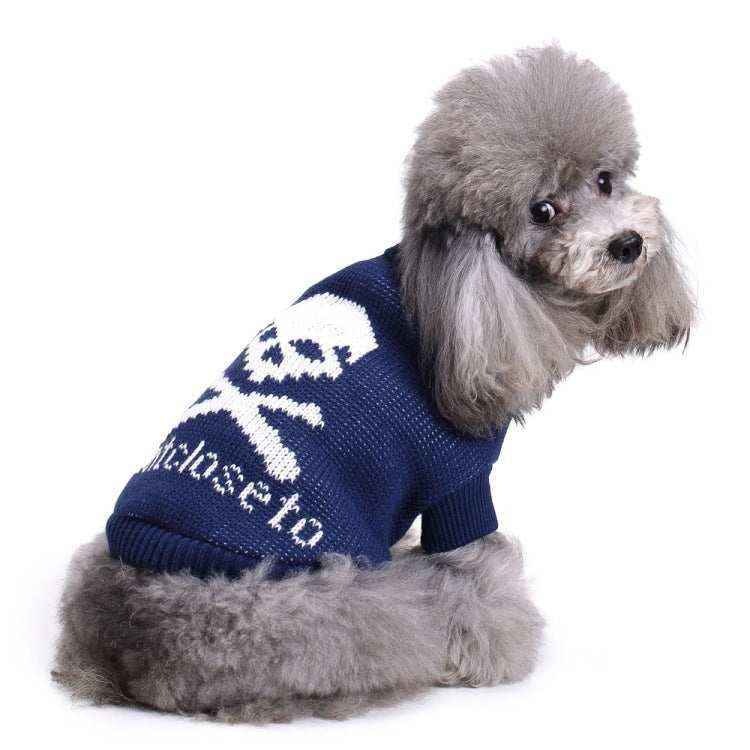 Gray poodle wearing navy blue sweater with white skull design sitting and looking back