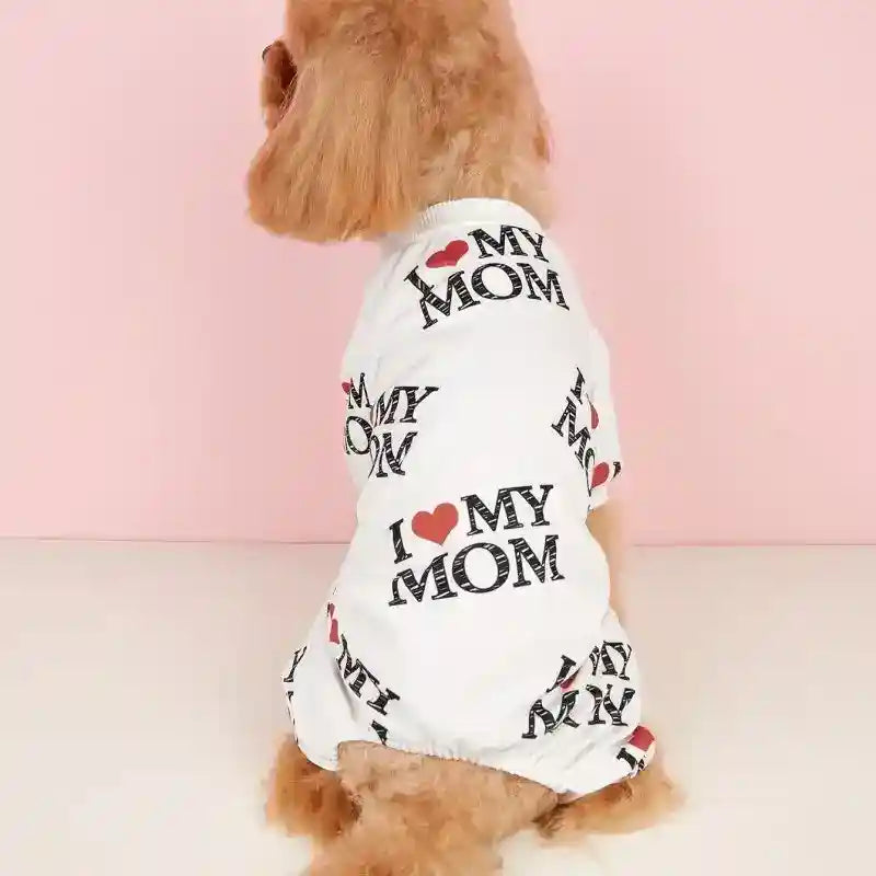 Small dog wearing white shirt with I love my mom text pattern on pink background
