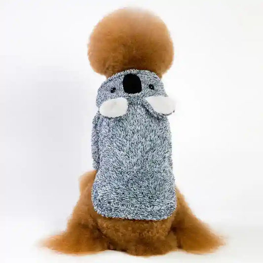 Brown poodle wearing a gray koala-themed knit sweater against white background