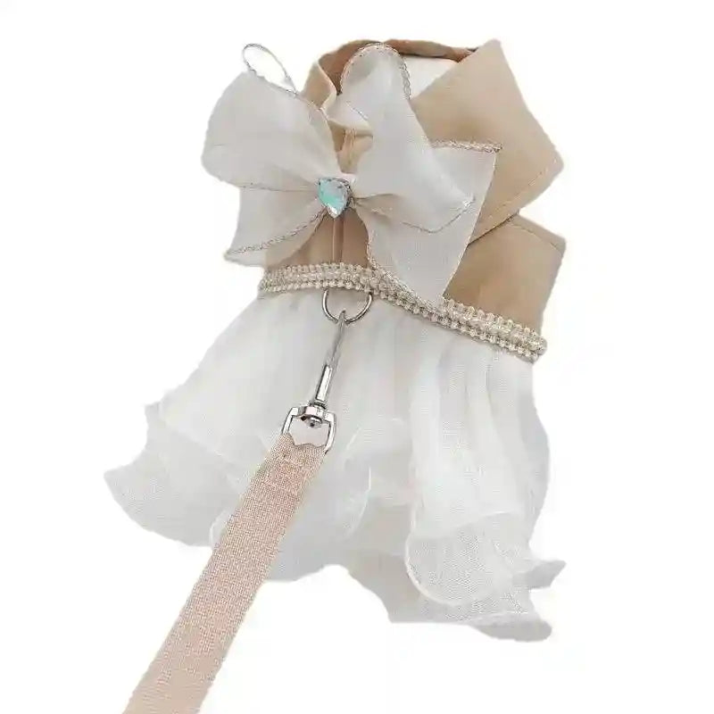 Elegant beige dog harness with white tulle skirt, pearl trim, large bow, and attached beige leash