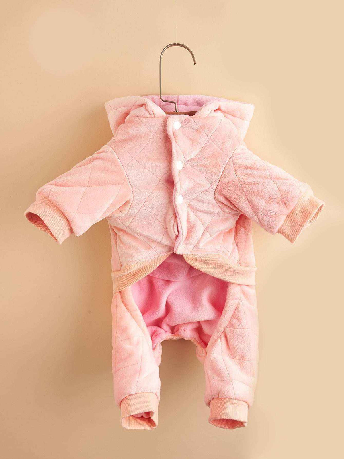 Pink quilted soft fleece baby jumpsuit with hood and snap buttons, displayed on hanger