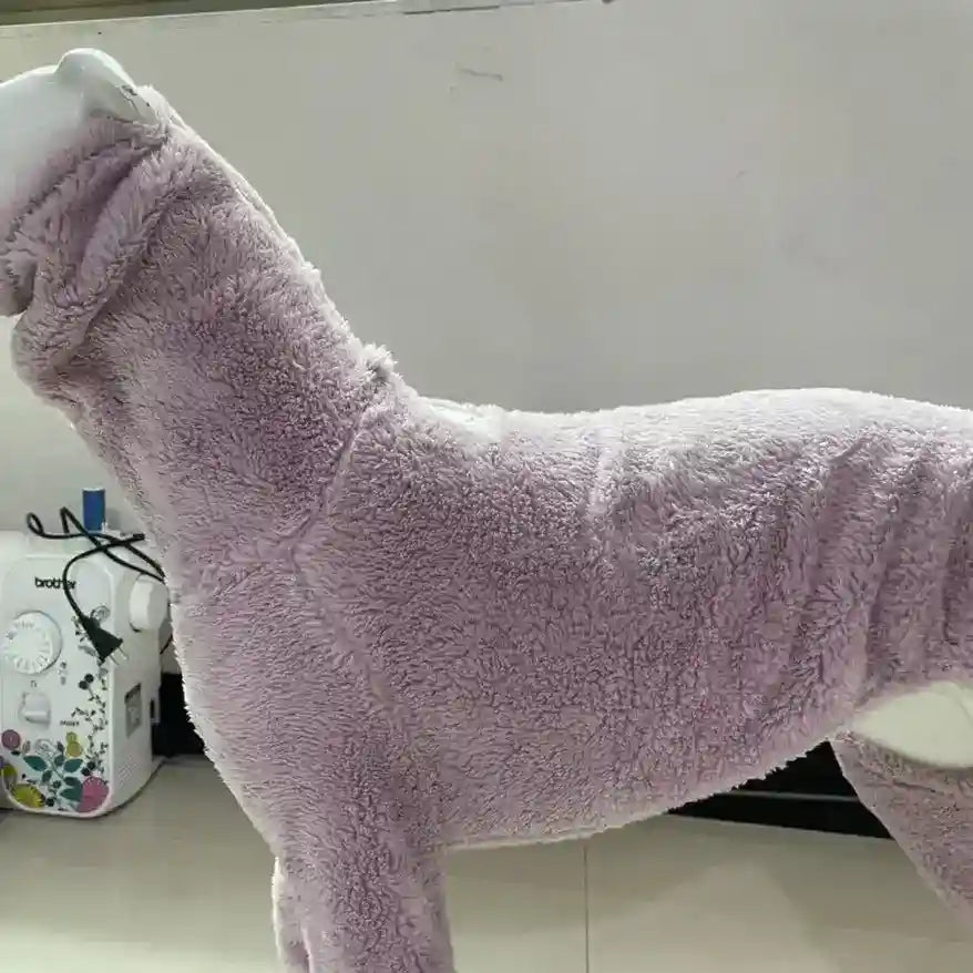Lavender fuzzy dog sweater displayed on white mannequin with sewing machine in background